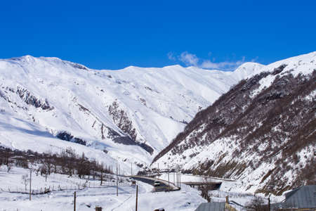 Snowy road in mountainsの写真素材