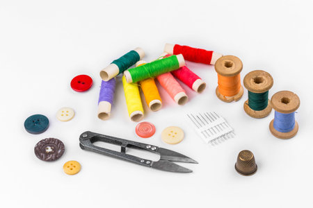 Colored thread with scissors on white background