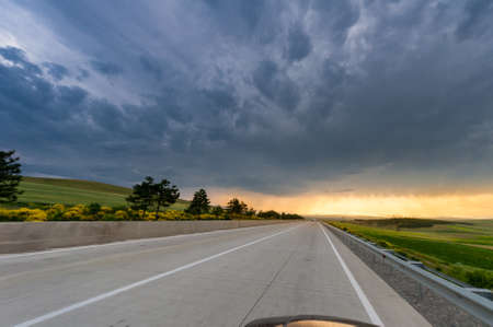 The Amazing sky above the long road at sunsetの写真素材