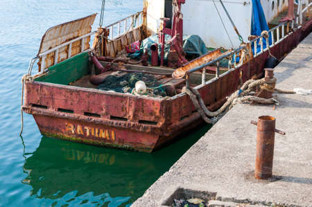 BATUMI  - JULY 6: view on a old red boat in the water near piereのeditorial素材