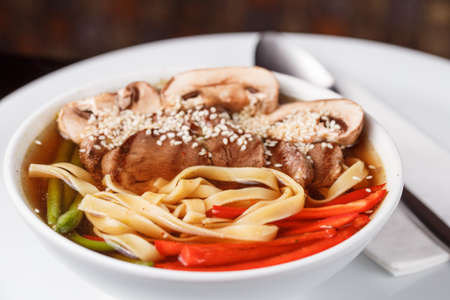 Asian noodle soup from above with chopsticksの写真素材