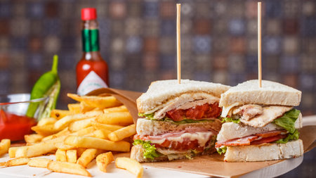 Delicious club sandwich with french fries at a dinerの写真素材