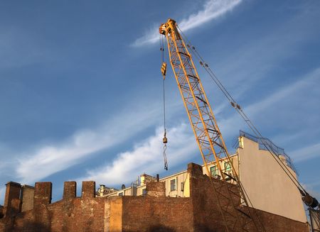   Color photograph cranes in the background of an old brick wall      の写真素材