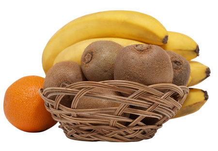 Color photo of kiwi fruit in a wicker basket against the backdrop of bananas and oranges       の写真素材