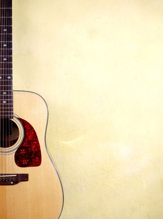 Color photo of an acoustic guitar near wallの写真素材