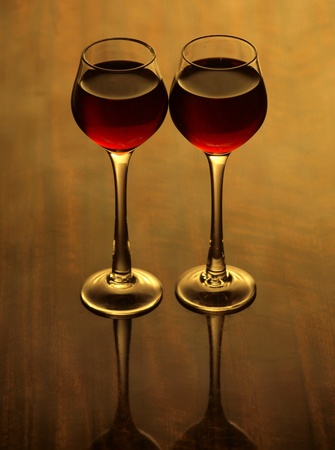 Color photo of a glass of red wine glasses on wood surface      の写真素材
