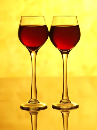 Color photo of a glass of red wine glasses on the mirror surface       の写真素材