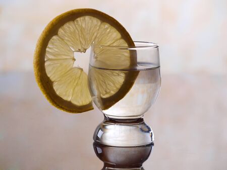 Color photo of a glass cup with tequila and lemon        の写真素材
