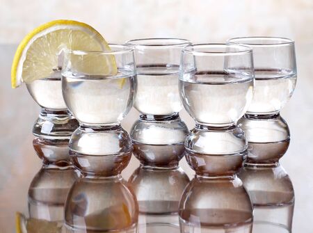 Color photo of a glass cup with tequila and lemon   の写真素材