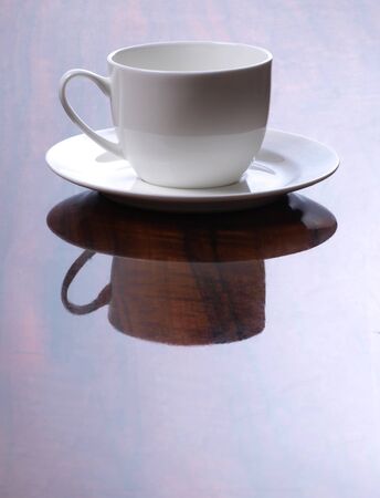 Color photo of a white cup on polished surface       の写真素材