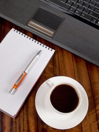 Color photo of a workplace with a laptop and a cup of coffee       の写真素材