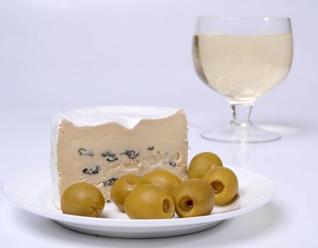 Color photo of green olives on a white plate        の写真素材