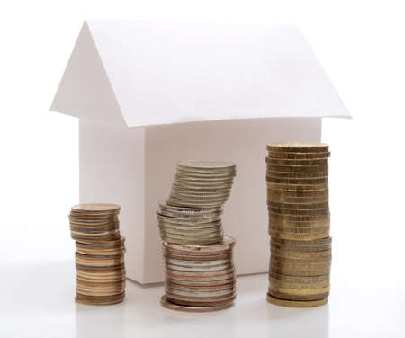 Color photo of a model home and coins       の写真素材