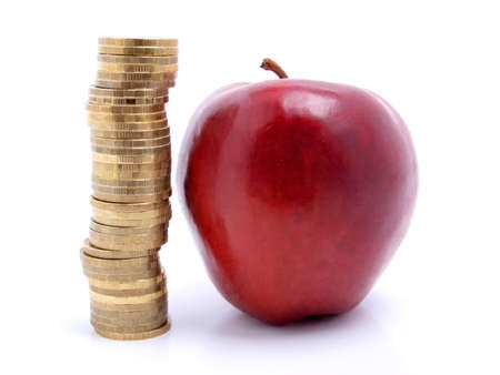 Color photo of an apple and a stack of coins    の写真素材