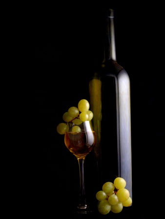 a branch of grapes and glass bottle      の写真素材