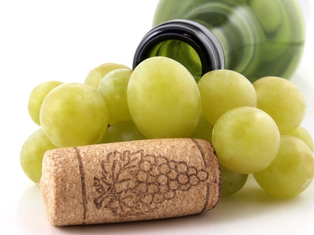 branch of grapes and bottle caps      の写真素材