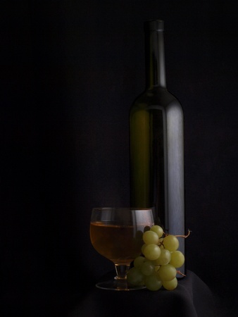 a branch of grapes and glass bottle     の写真素材