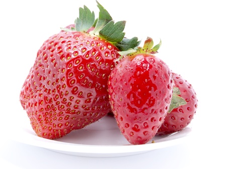 Photograph of cut strawberries on a white plate    の写真素材
