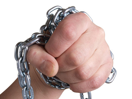 Color photo of a man's hand and a metal chain       の写真素材