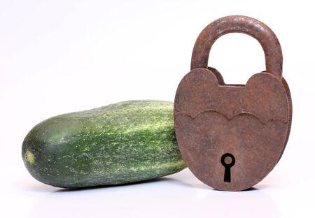 Color photo of green cucumber and padlockの写真素材