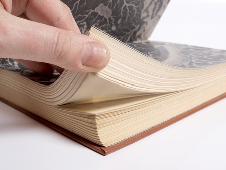 Color photo of an old book and hands      の写真素材