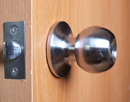 Color photo of a metal handle on a wooden door      の写真素材