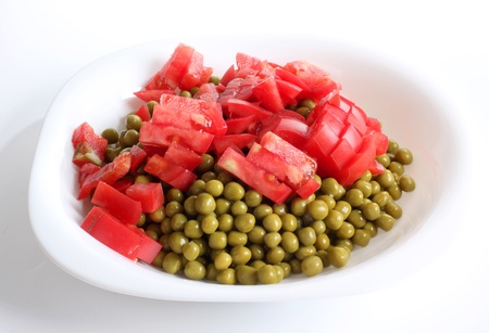 Color photograph of green peas and tomatoの写真素材