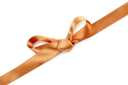 Color photo of a bow on gold ribbonの写真素材
