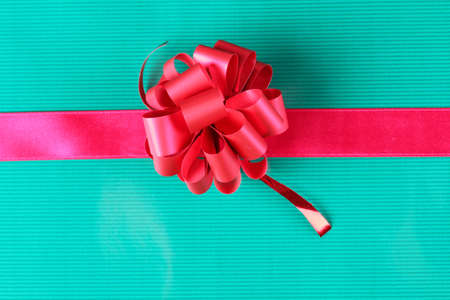 Color photo of a bow on red ribbonの写真素材
