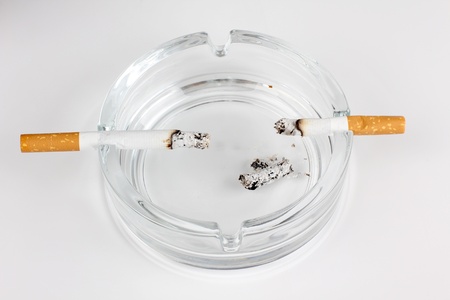 Color photo of a glass ashtray and cigaretteの写真素材