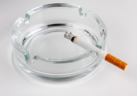Color photo of a glass ashtray and cigaretteの写真素材
