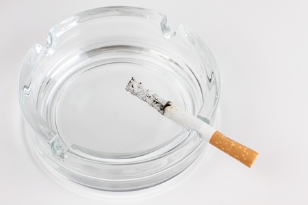 Color photo of a glass ashtray and cigaretteの写真素材