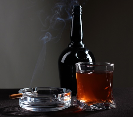 Color photo of a glass of whiskey and cigarettesの写真素材
