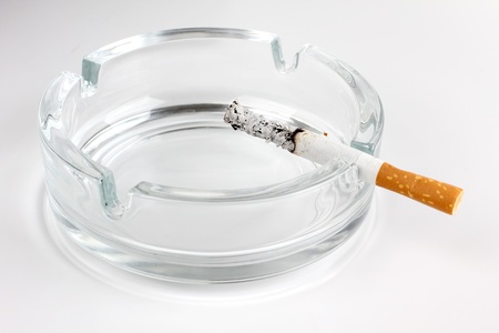 Color photo of a glass ashtray and cigaretteの写真素材