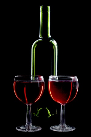 Color photo of a two glass bottles with a black backgroundの写真素材