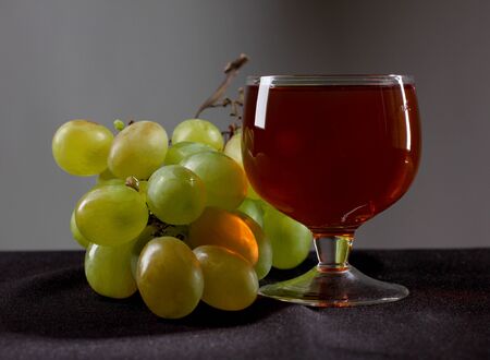 Color photo of a branch of grapes and glassの写真素材