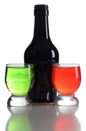 Color photograph of bottle and cocktails in glass beakersの写真素材
