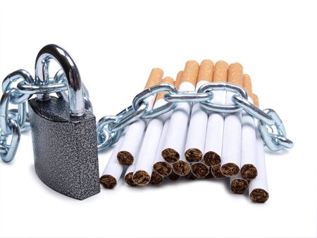 Color photo of pile of cigarettes and a padlock with chain        の写真素材