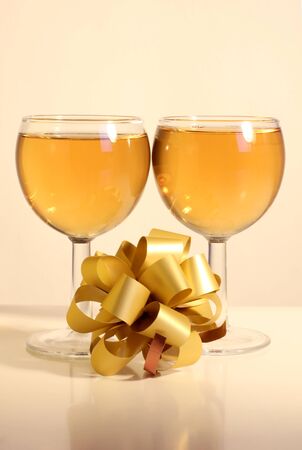Color photo of wine glasses and a gold ribbonの写真素材