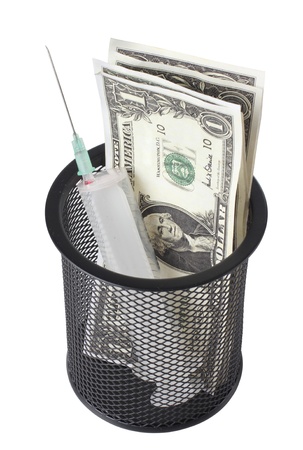 Color photo of a medical syringe and paper moneyの写真素材