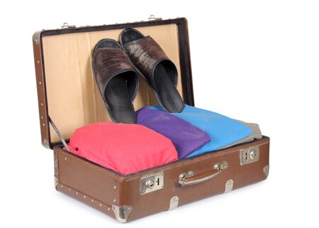 Color photo of an old suitcase with clothingの写真素材