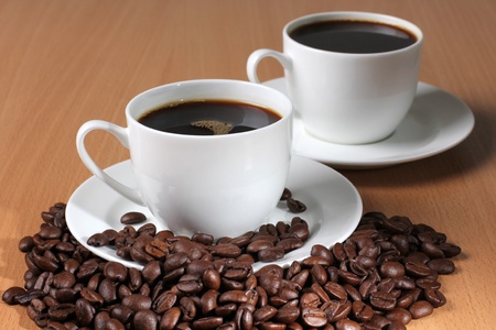 Color photo of coffee beans and a white cupの写真素材