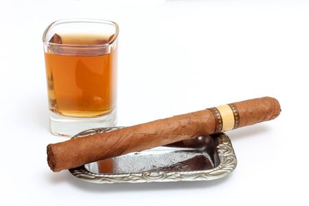 Color photo of a glass of whiskey and a big cigarの写真素材