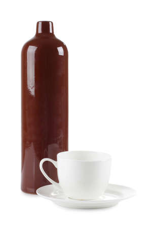 Color photo of a tea cup and a ceramic bottle of balsamの写真素材