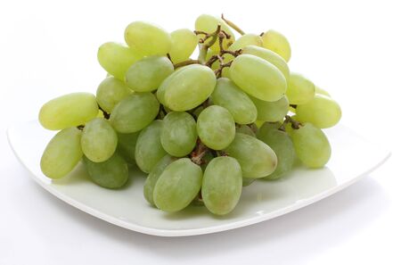Green grapes on white plateの写真素材