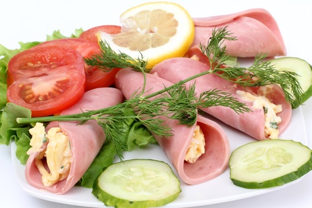  sausage rolls and vegetables on plateの写真素材