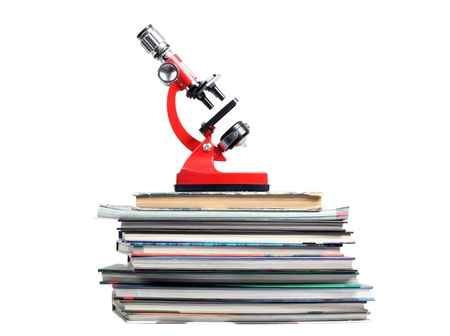 Color photo of a microscope on stack of booksの写真素材