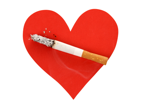 Broken heart and cigarette butt on a white backgroundの写真素材
