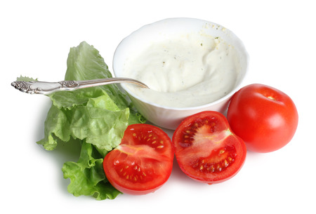 Sauce and diced vegetables in porcelain plate on a white backgroundの写真素材