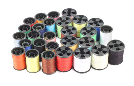 Spools of colored thread on a white background